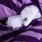 Close-up of a purple and lilac striped duvet cover with a magnet detail.