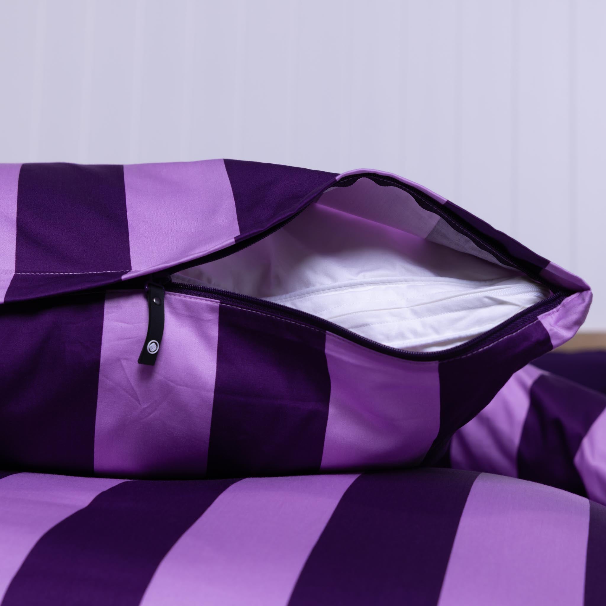 Purple and lilac striped invisible-zipper pillowcase half unzipped;