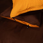 Close-up of a yellow and brown sleeping bag with a zipper.