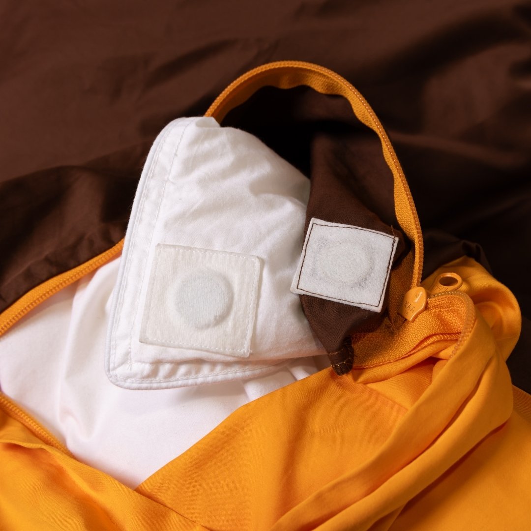 Close-up of a yellow garment with white patches on a brown background