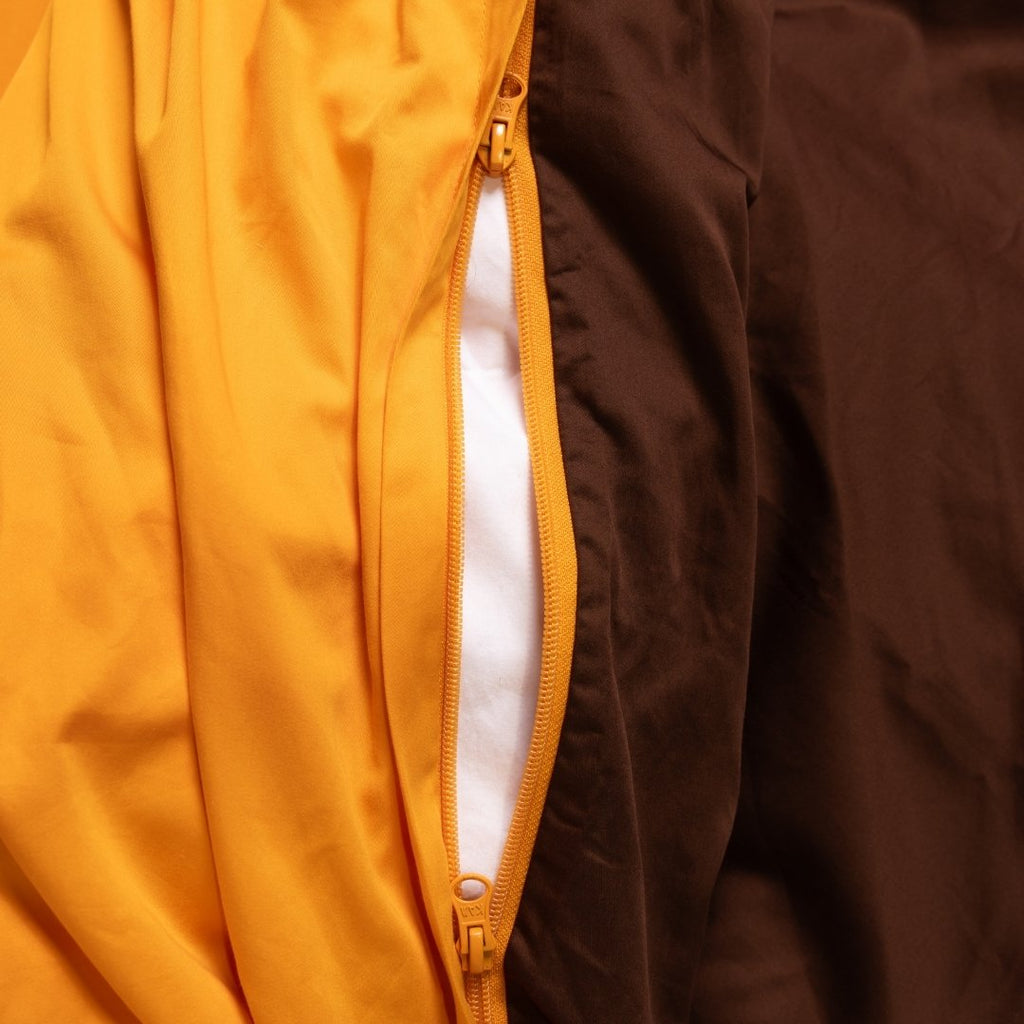 Close-up of a yellow jacket with a zipper, showing the inside lining.
