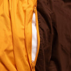 Close-up of a yellow jacket with a zipper, showing the inside lining.