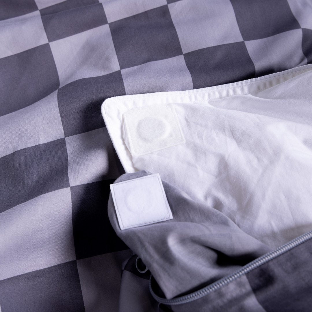Grey checkered quilt cover with quilt insert showing magnetic clips in corners.
