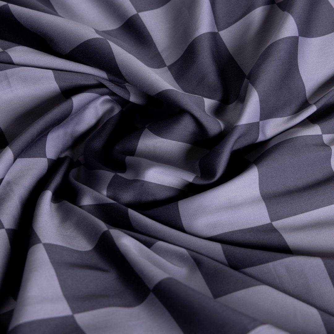 Checkered fabric pattern in shades of gray.