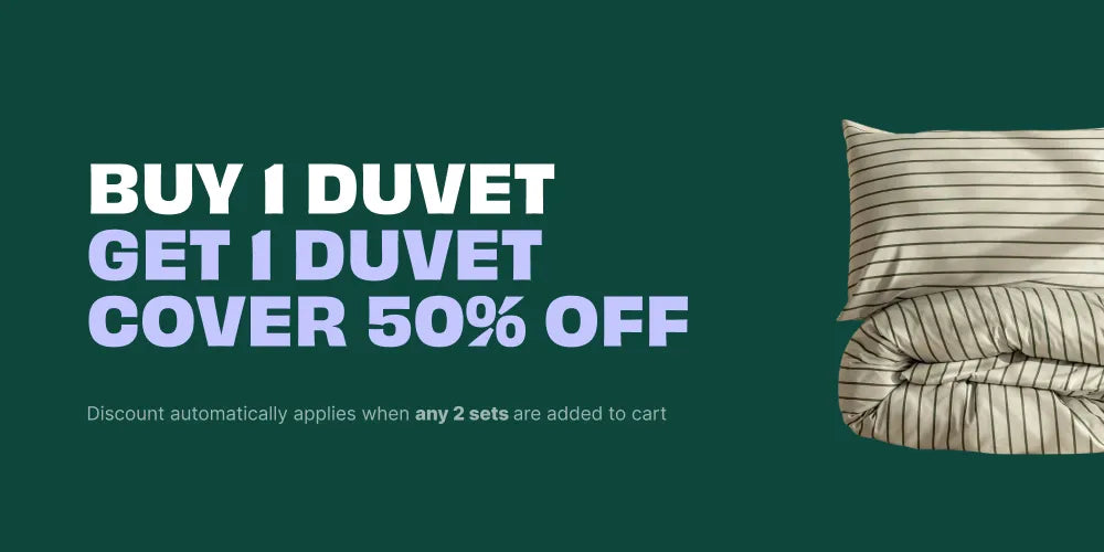 Promotional banner with a dark green background, large white and lavender text reading 'BUY 1 DUVET GET 1 DUVET COVER 50% OFF,' plus a small inset photo of a striped duvet cover and pillow on the right.