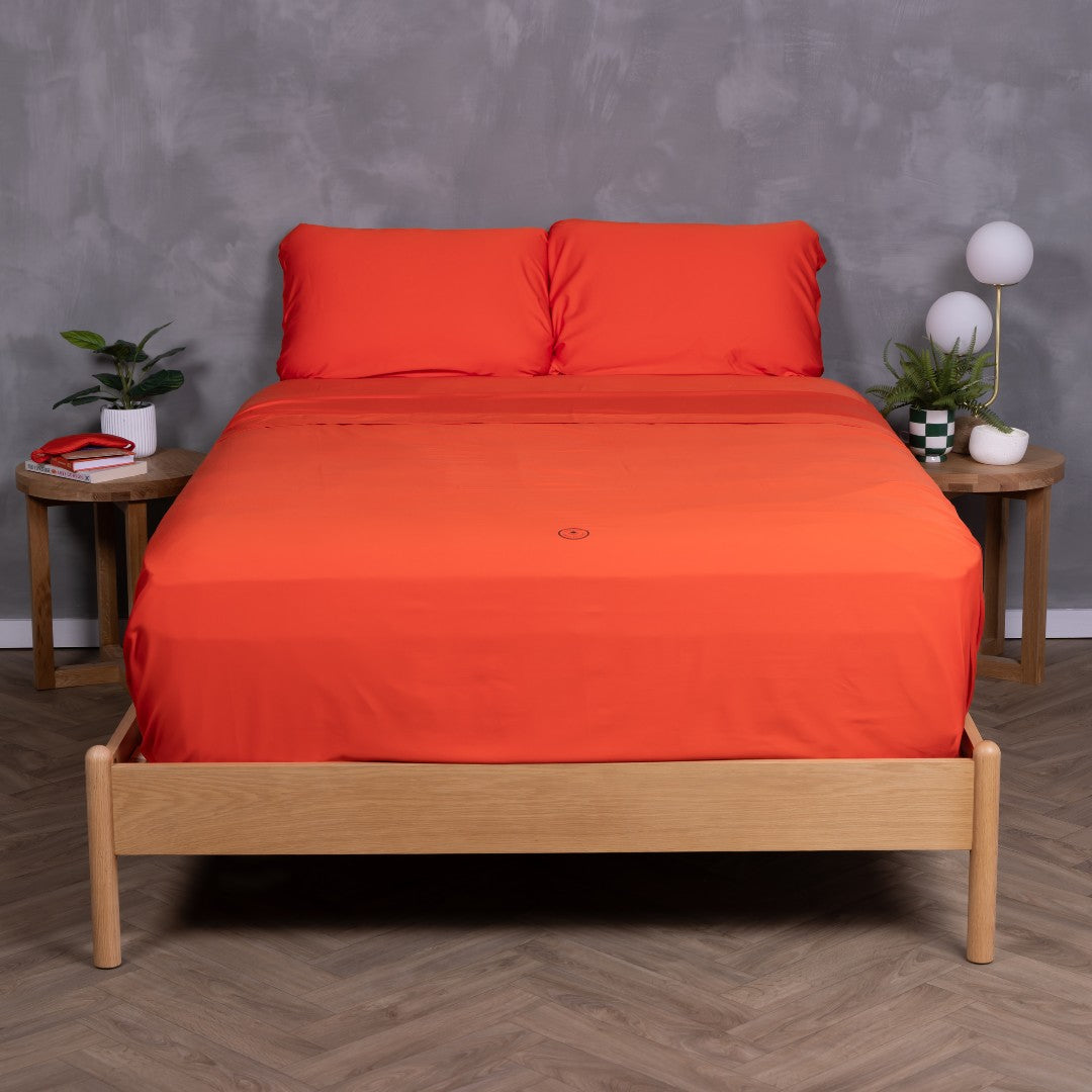 Full view of the Red Rock bedding set, featuring pillowcases and top sheet tucked into bed frame.