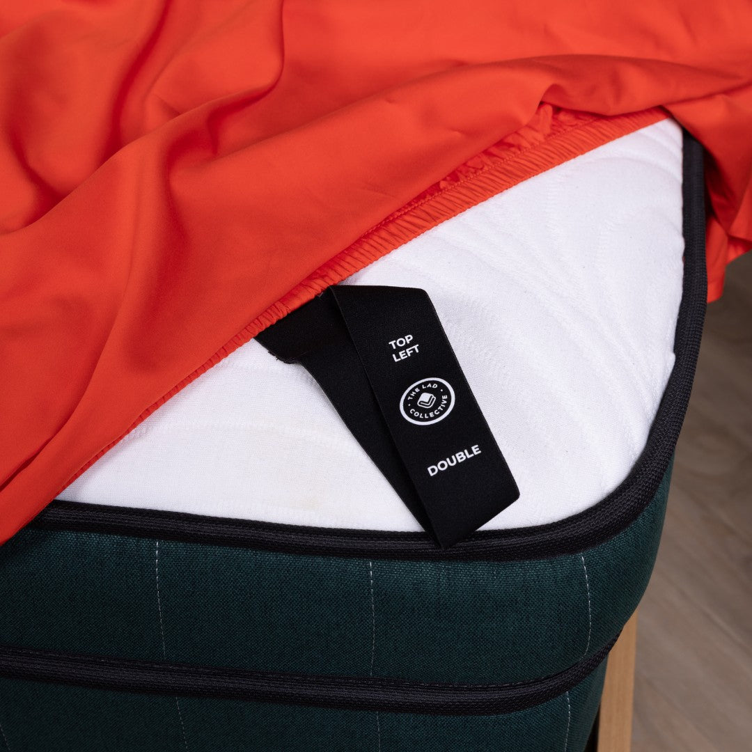 Close up of the labeled corner loop strap on Red Rock fitted sheet. 