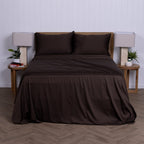 Brown bed sheets & pillowcases on a bed with matching pillows in a minimalistic bedroom setting.