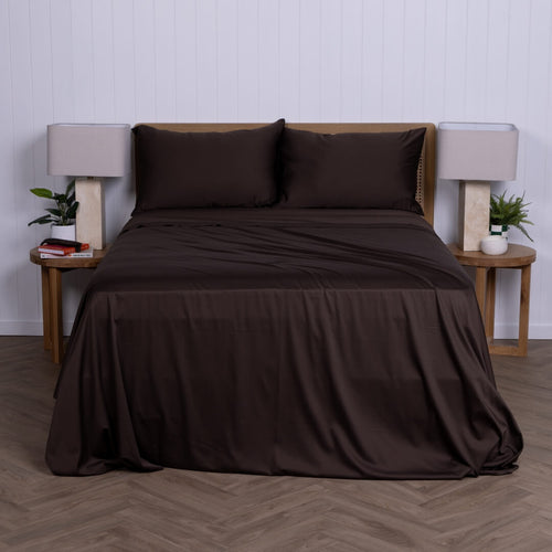 Brown bed sheets & pillowcases on a bed with matching pillows in a minimalistic bedroom setting.
