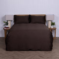 Brown duvet cover set on a bed with matching pillows against a white wall.