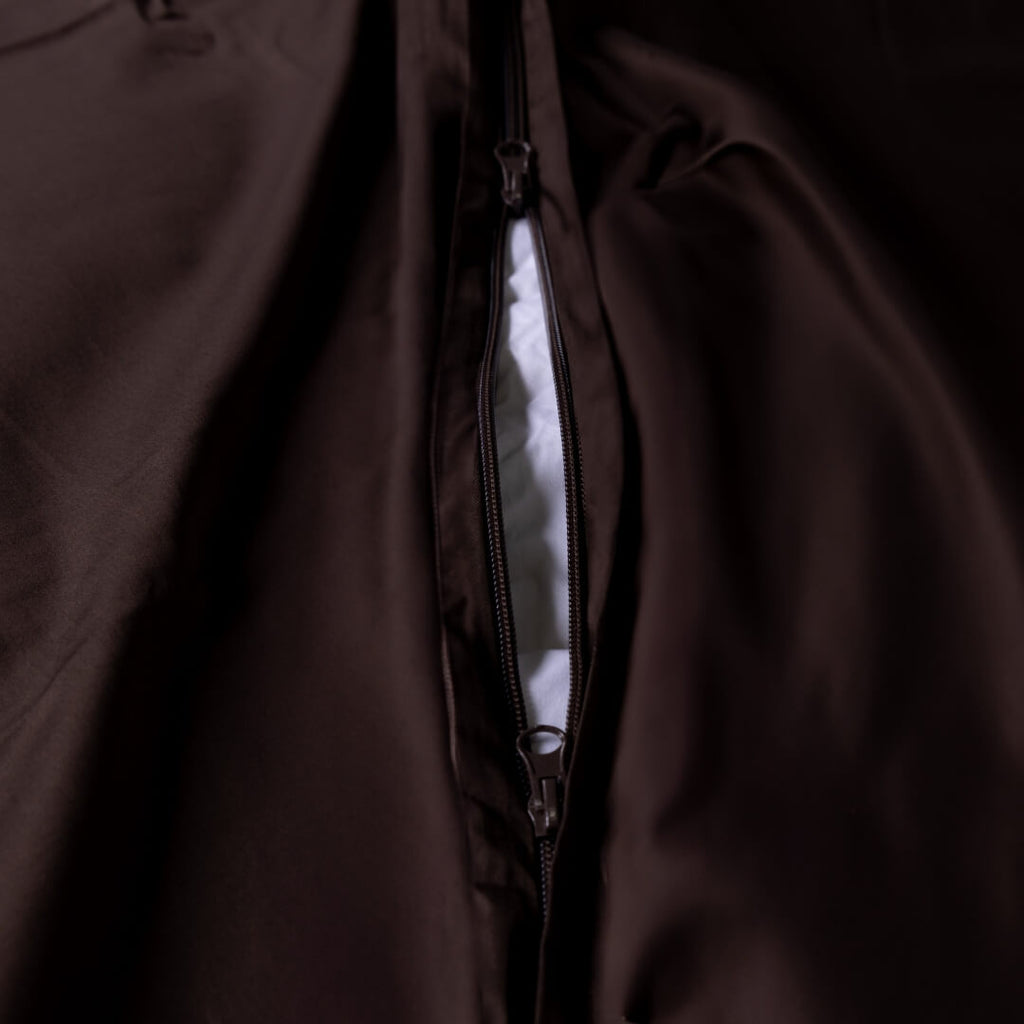 Close-up of a brown duvet cover with a zipper at the base.