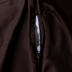 Close-up of a brown duvet cover with a zipper at the base.