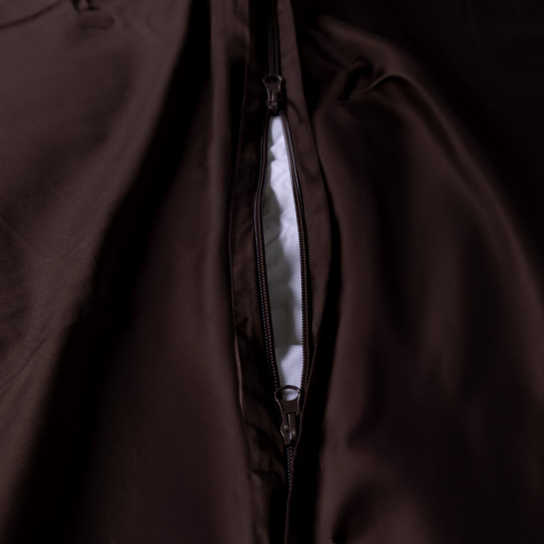 Close-up of a brown duvet cover with a zipper at the base.