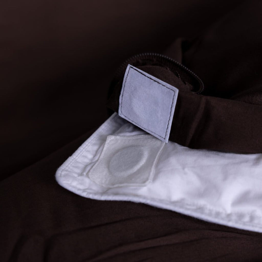 Close-up of the magnetic clips on a brown duvet-cover.
