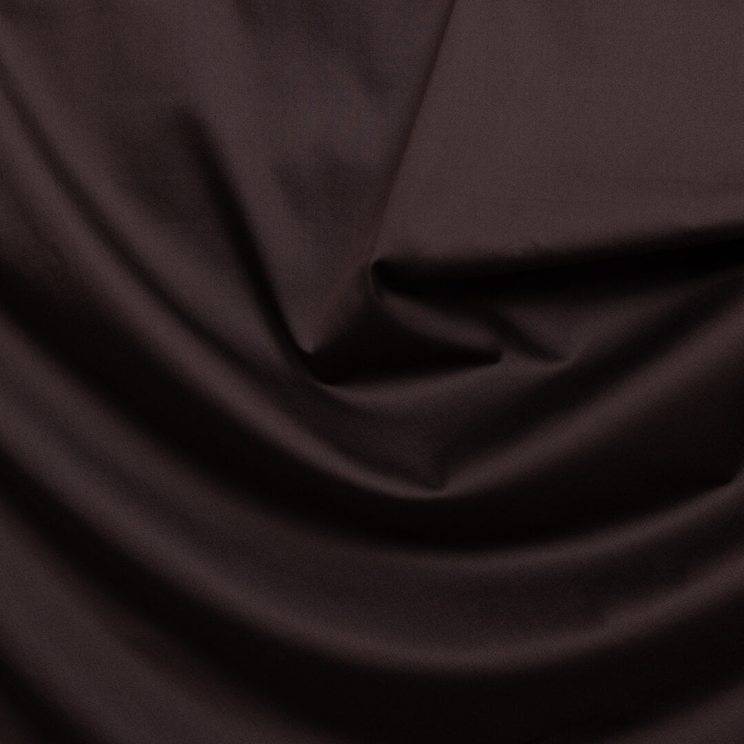 Dark brown fabric with folds.